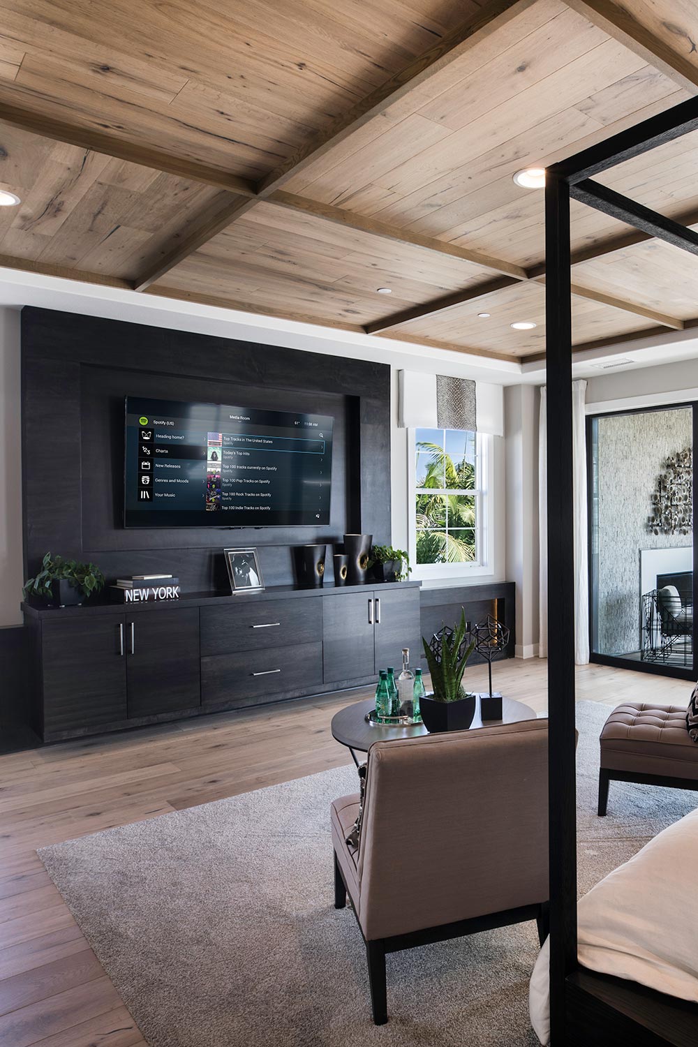 Control4 on a TV in a modern dark bedroom