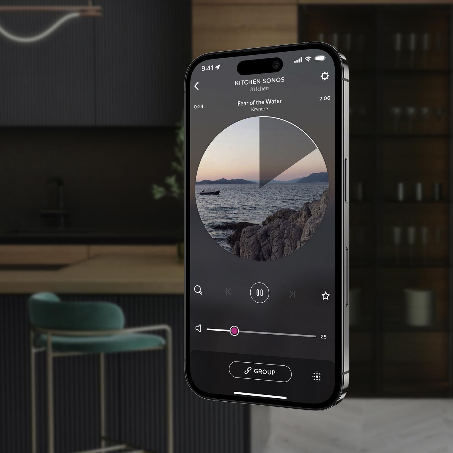 A smartphone displaying the Josh AI music player interface with a song playing, set against a modern kitchen background with sleek design elements.