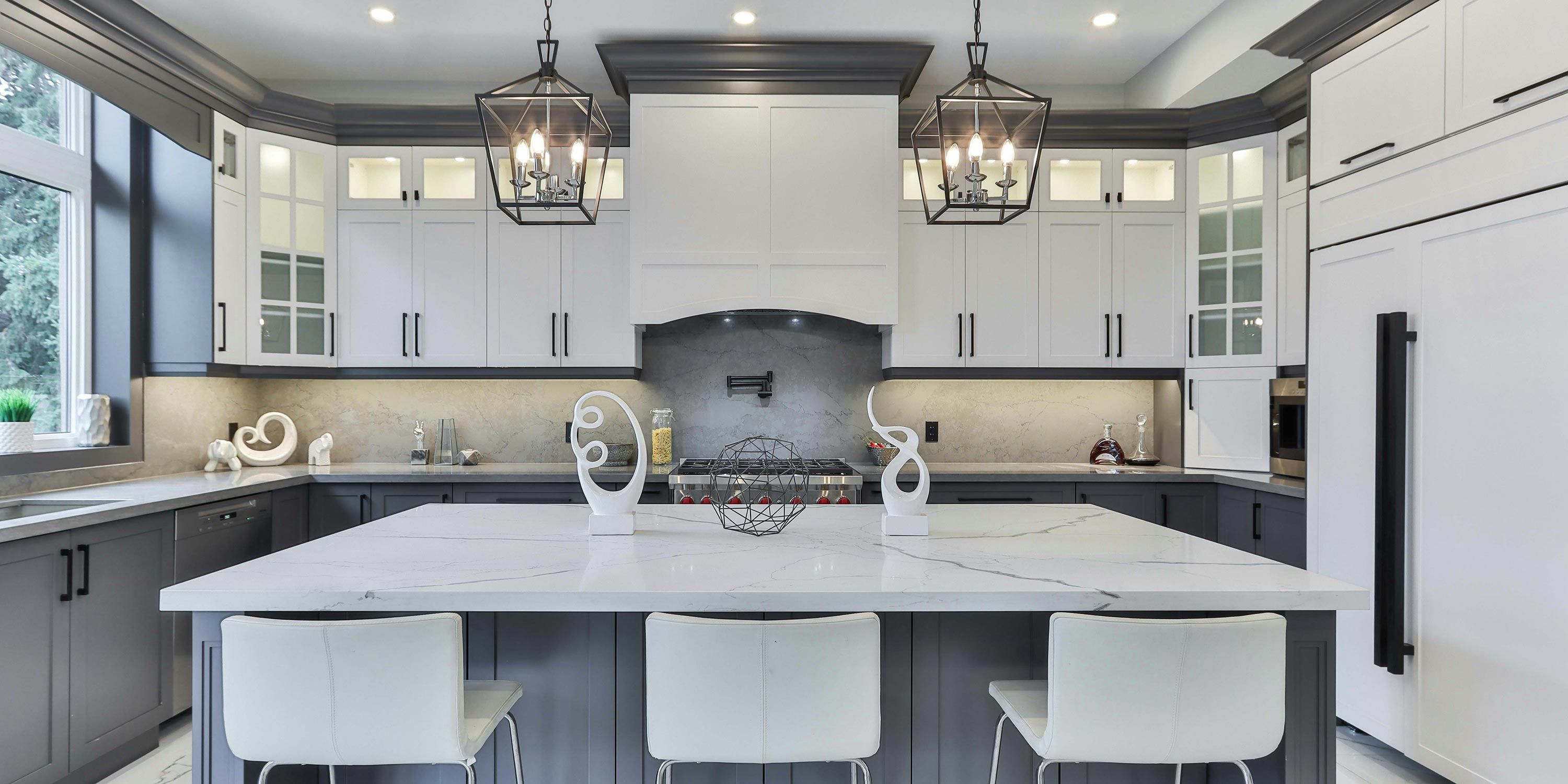 Sleek kitchen with a large island, modern appliances, and stylish pendant lighting.