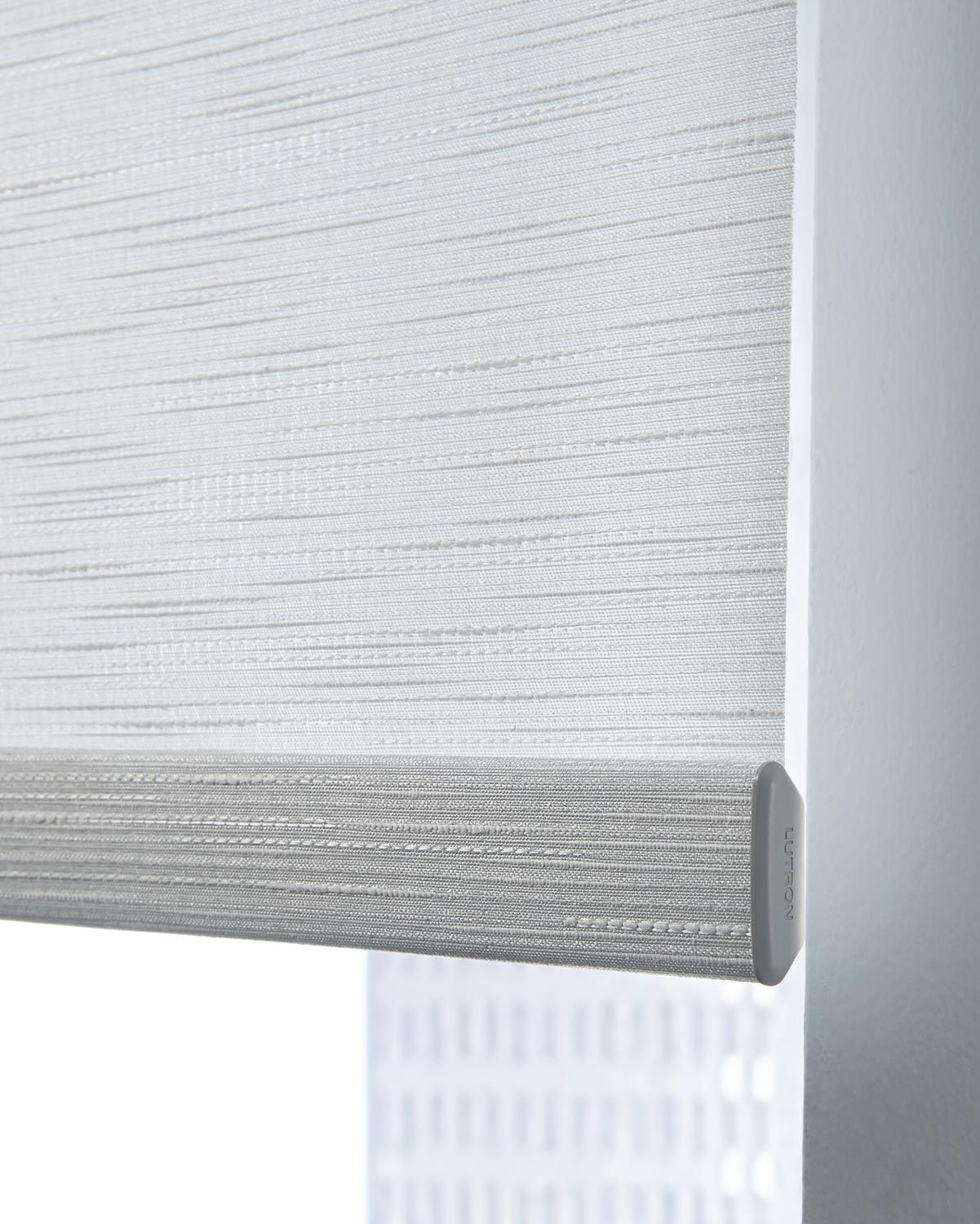 Close-up of a Lutron roller shade fabric, showcasing the detailed texture and high-quality material in a neutral color.