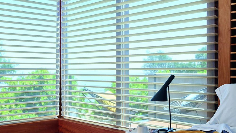 Horizontal Sheer Blinds by Lutron in an olive green bedroom