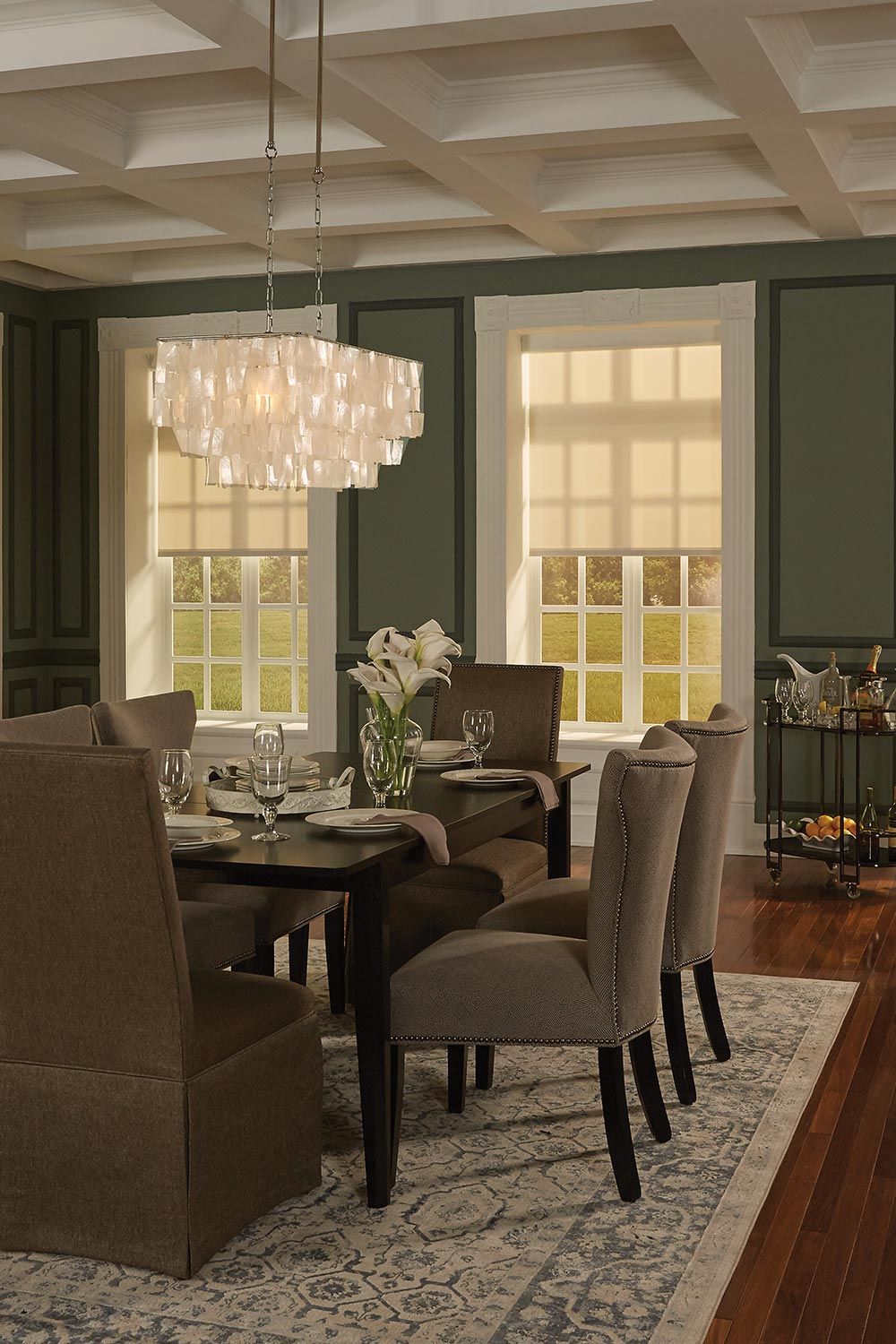 Lutron shades in a green and taupe dining room