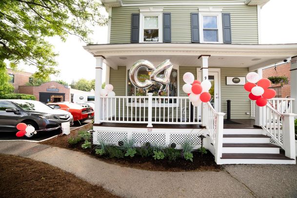 Charming house with a porch, balloons, and a large metallic balloon letter C4.