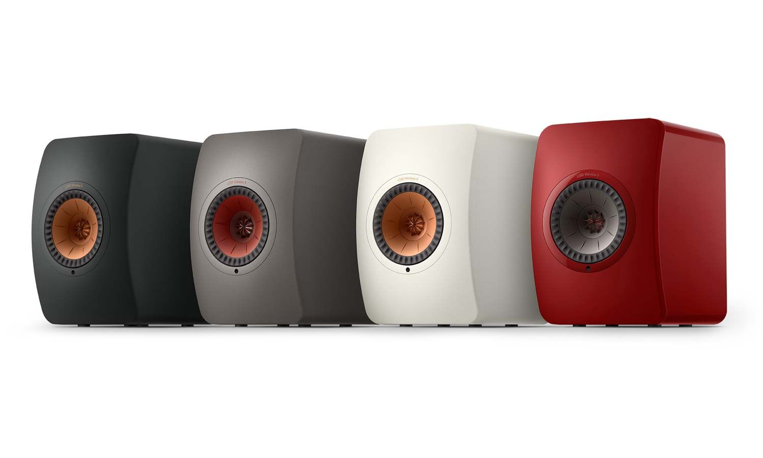 Four KEF LS50 Wireless speakers in black, grey, white, and red colors lined up against a white background.